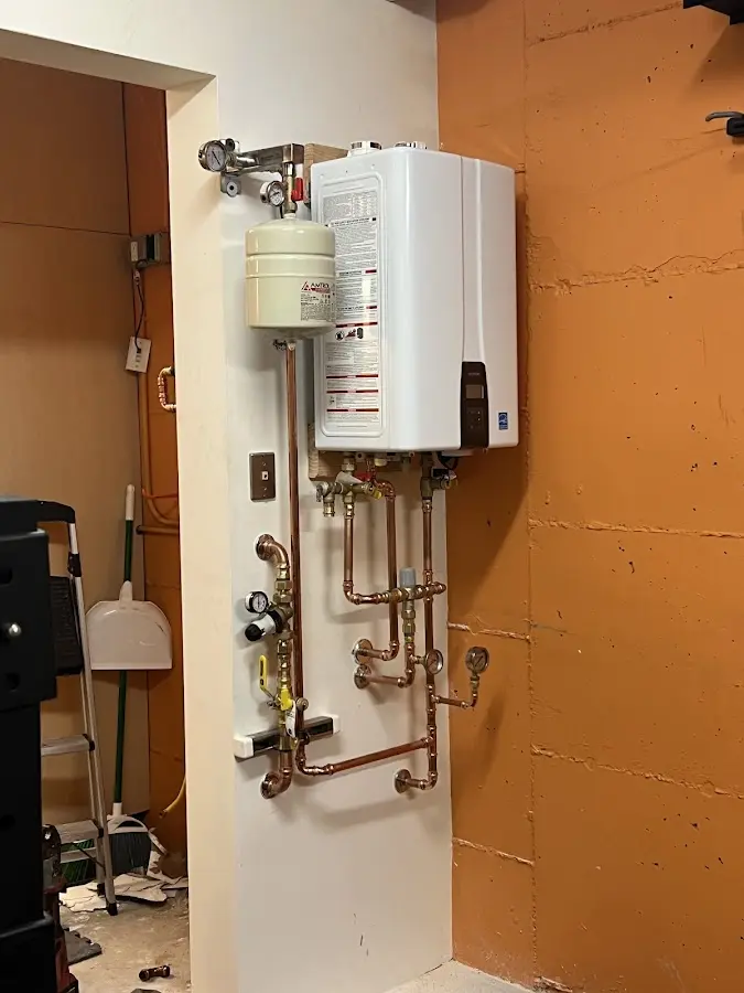 Plumbing technician inspecting water heater connections in Mammoth Lakes